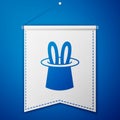 Blue Magician hat and rabbit ears icon isolated on blue background. Magic trick. Mystery entertainment concept. White Royalty Free Stock Photo