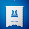 Blue Magician hat and rabbit ears icon isolated on blue background. Magic trick. Mystery entertainment concept. White Royalty Free Stock Photo