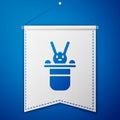 Blue Magician hat and rabbit icon isolated on blue background. Magic trick. Mystery entertainment concept. White pennant