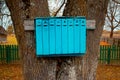 Blue mailboxes on a tree. In the village. Royalty Free Stock Photo