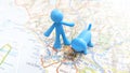 A blue man and dog plastic figure standing on Rome on a map of Italy