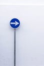 Blue mandatory direction sign on white background