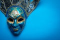 Blue Mardi Gras or carnival jester mask on a blue background