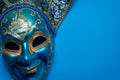 Blue Mardi Gras or carnival jester mask on a blue background