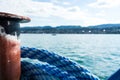 Blue marine rope on ship with lake water and landscape Royalty Free Stock Photo