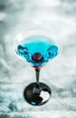 Blue martini cocktail with cherry on the rustic background Royalty Free Stock Photo