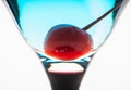Blue martini cocktail with cherry on the rustic background Royalty Free Stock Photo