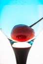 Blue martini cocktail with cherry on the white background Royalty Free Stock Photo