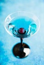Blue martini cocktail with cherry on the rustic background Royalty Free Stock Photo