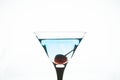 Blue martini cocktail with cherry on the white background Royalty Free Stock Photo