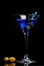 Blue martini with olives Royalty Free Stock Photo