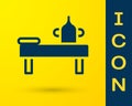 Blue Massage table with oil icon isolated on yellow background. Vector Royalty Free Stock Photo