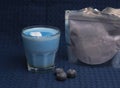 blue matcha latte and blue anchan powder in zip lock bag on blue kitchen towel Royalty Free Stock Photo