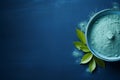 Blue matcha tea powder on dark blue background with copy space. AI generated