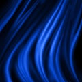 Blue material draped in wavy folds, elegant luxury blue background design with black shadows Royalty Free Stock Photo