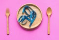 Blue measuring tape on the wood plate for weight loss, colourful ping background.