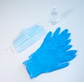 Blue medical face mask, nitrile gloves and isopropyl alcohol spray