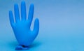 Blue medical glove inflated. On yellow background with copy space.