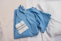 Blue medical operation shirt and white operation underware lying on a hospital bed