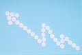 Blue medicine background with arrow of white pills in the form of success graph. Royalty Free Stock Photo