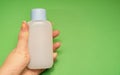 Blue medicine bottle in left female hand Royalty Free Stock Photo