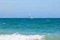 Blue Mediterranean Sea, clear skies and a sailing ship with white sailing and a lot of sailboats. Regatta Royalty Free Stock Photo