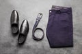 Blue men`s trousers with black leather shoes and a belt Royalty Free Stock Photo