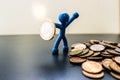 Blue men stand with a euro coin as a shield with pile of russian junk coins success concept Royalty Free Stock Photo