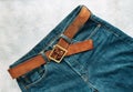 Blue mens denim pants, jeans, with a leather belt, fashion clothing concept. View from above with copy space