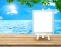 Blue Menu board with easel on wood table at sea with tree and s Royalty Free Stock Photo