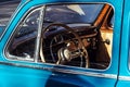 Blue Mercedes-Benz 220S Ponton Limousine retro car close-up view on Steering wheel and dashboard