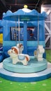 Blue merry go round mini ride or small carousel horse ride indoor playground Royalty Free Stock Photo