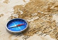 Blue metal compass on the old world map Royalty Free Stock Photo