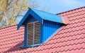 Blue metal tile roof with a window in the form of a house Royalty Free Stock Photo