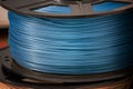 Blue metallic glossy PLA plastic filament for 3D printer. Royalty Free Stock Photo