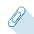 Blue metallic paperclip attached to the corner of a sheet of paper Royalty Free Stock Photo