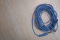 Audio Mini Jack Cable for microphone isolated on wooden background . Blue Microphone and headphone splitter cable