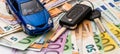 blue mini car with key with euro money on desk Royalty Free Stock Photo