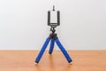 Blue mini flexible tripod for smartphones. Tripod for phone