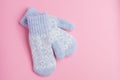 Blue mitten on pink background