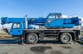 Blue mobile crane truck for heavy load - blue sky Royalty Free Stock Photo