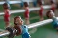 Blue model player on a foosball game Royalty Free Stock Photo