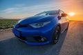 Blue modern hybrid car at the sunset. Front side view photo Royalty Free Stock Photo