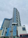 Blue modern luxury glass building low angle on a cloudy sky. Muong Thanh Hotel in Quang Ninh, Vietnam Royalty Free Stock Photo