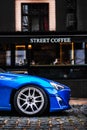 Blue modern sports car parked on the street in the city center. alloy wheels on car Royalty Free Stock Photo