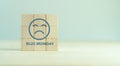 Blue monday concept. Wooden cubes with a sad face drawn. Monday blues Royalty Free Stock Photo