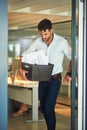 Blue Monday. a stressed businessman carrying his box of possessions after getting fired from his job. Royalty Free Stock Photo