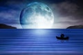 Blue moon rising out of the sea lovers background