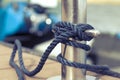 mooring rope on a metal bollard close-up on a boat background Royalty Free Stock Photo