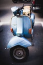 blue moped vespa in street of Rome Italy